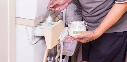 closeup-adding-baking-soda-to-washer